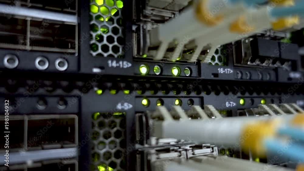 working data servers with flashing LED lights. Lights and connections on network server. Optical server close up