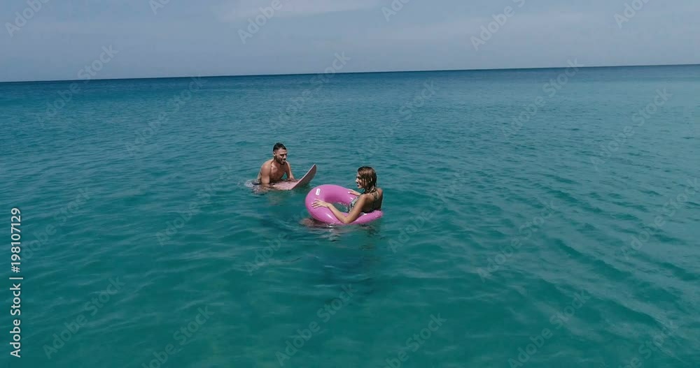 Aerial view of couple enjoying their holidays in amazing clear sea water Aerial view of couple enjoying their holidays in amazing clear sea water