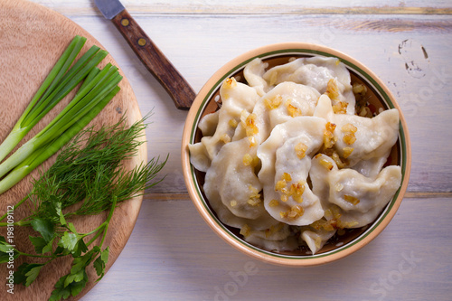 Plate of pierogi or varenyky, vareniki, Dumplings, filled with beef meat and served with fried onion. Pyrohy - dumplings with filling. View from above, top, overhead