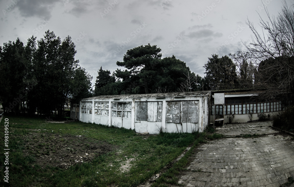 Abandoned village house building in Baku Botanical garden. Nobody in the park with trees. Springtime