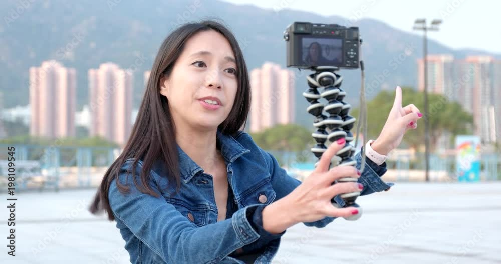 Woman talking on camera for making vlog