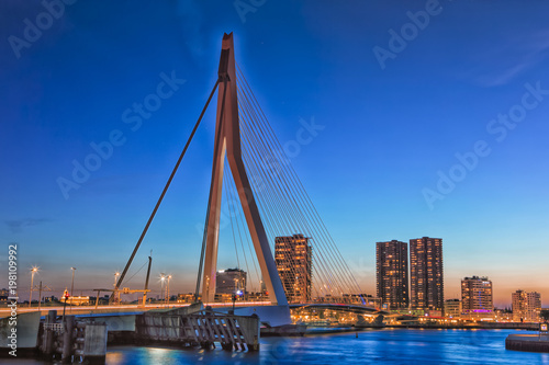 Travel Concepts and Ideas. Beautiful and Astonishing View of Rotterdam Skyline with Erasmus Bridge on Foregorund During Blue Hour.