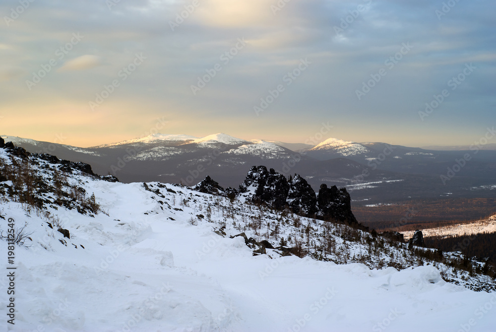 landscape - northern dawn in snowy winter mountains; view from the slope of the mount Konzhakovskiy Kamen.