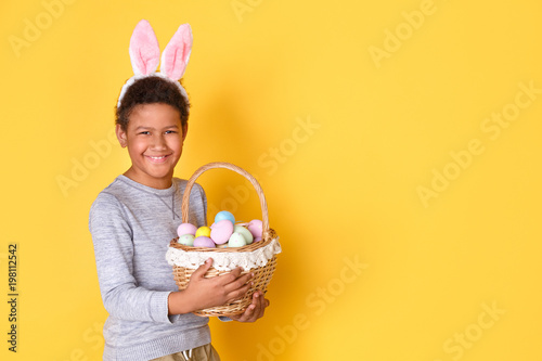 Photography One boy in bunny ears studio isolated on yellow wall easter celebration concept