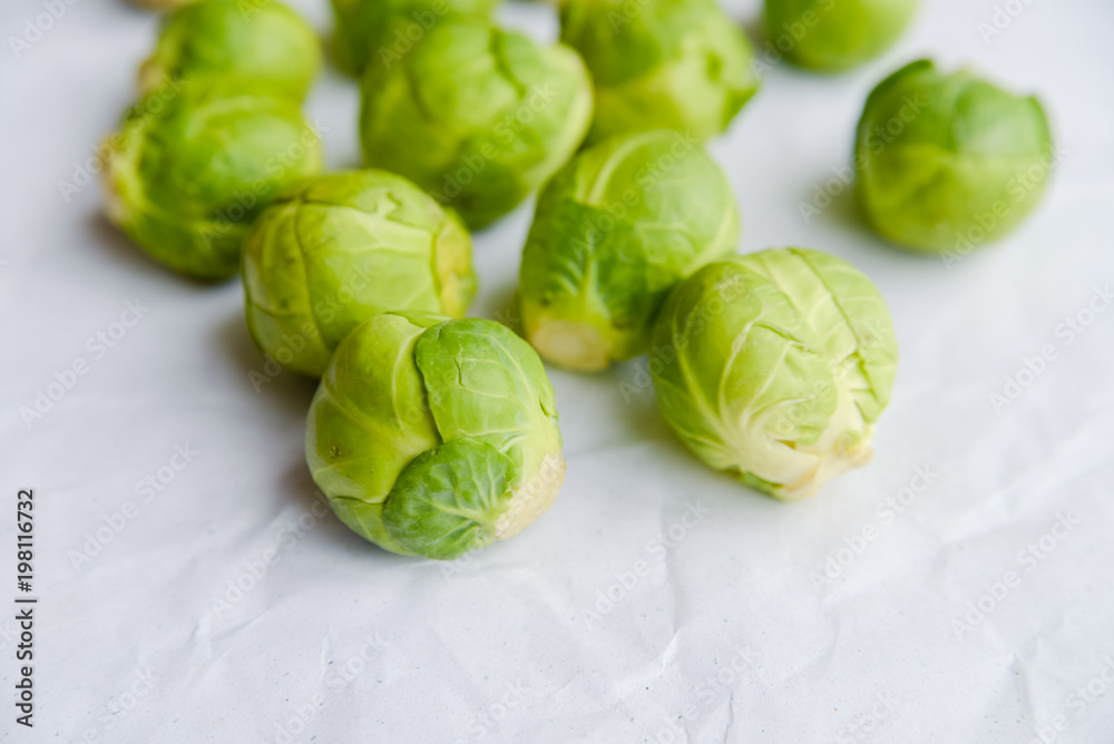 Brussels sprouts green vegetables on light table background. Flat lay close up top view copyspace design. Health food lifestyle Brussels sprouts green vegetables on light table background. Flat lay close up top view copyspace design. Health food lifestyle