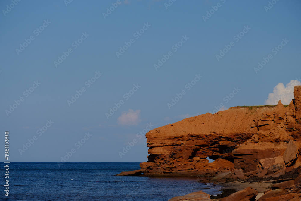 Naklejka premium Erosion of the cliffs along the red cliffs of North Rustico and Green Gables on the Gulf of St Lawrence