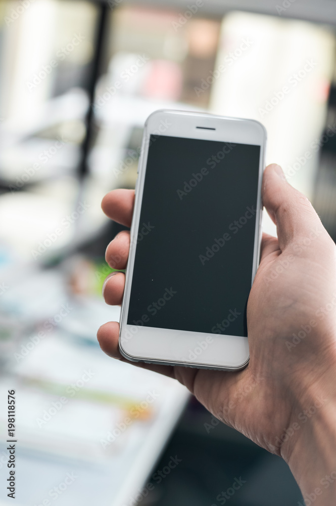 Hand hold mobile phone, person using smartphone. Top view closeup on black screen digital device mock up. Marketing technology design surface background, communication lifestyle Hand hold mobile phone, person using smartphone. Top view closeup on black screen digital device mock up. Marketing technology design surface background, communication lifestyle