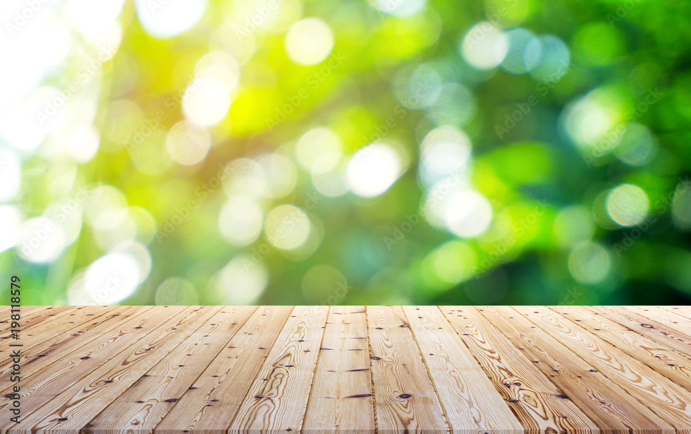 Perspective brown wooden board empty table in front of nature with softlight and green bokeh on background - can be used for display or montage your products.Mock up for display of product. Perspective brown wooden board empty table in front of nature with softlight and green bokeh on background - can be used for display or montage your products.Mock up for display of product.