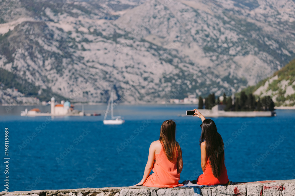 two girls travelling sea and mountains view in Montenegro