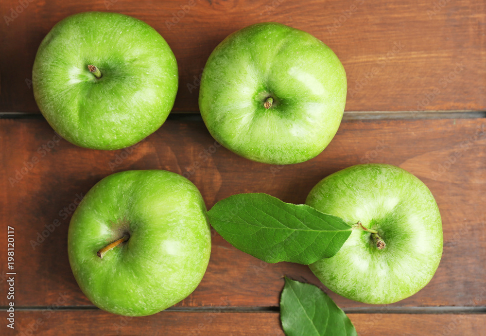 Fresh green apples on wooden background, top view Fresh green apples on wooden background, top view
