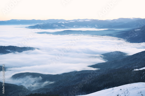 Beautiful landscape with foggy mountains in wintertime