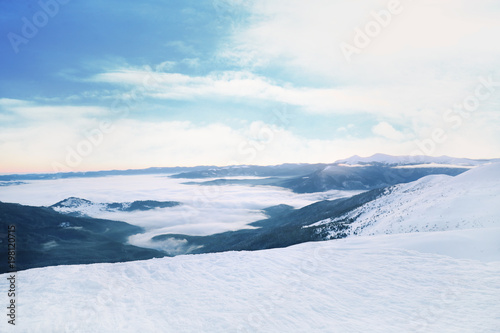 Snowy landscape with mountains on winter day