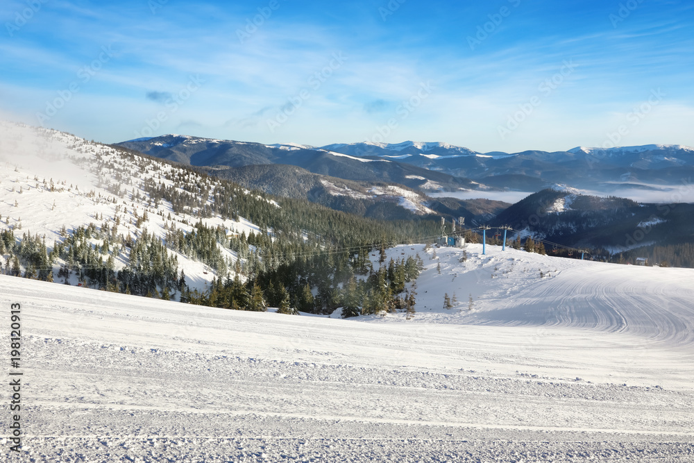Ski slope at snowy resort on winter day Ski slope at snowy resort on winter day