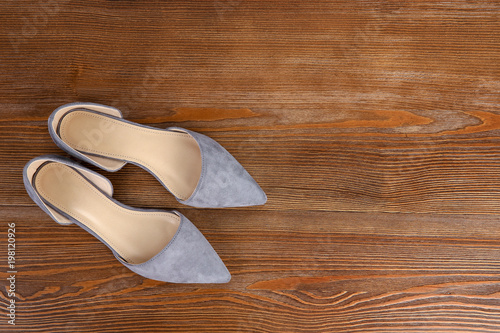 Pair of female shoes on wooden background