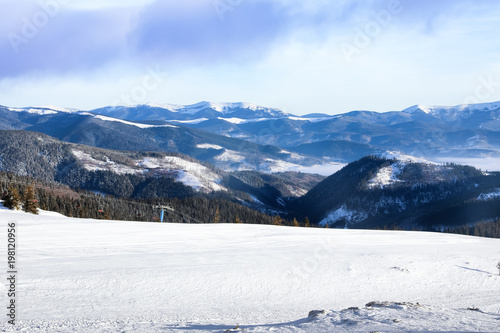 Ski slope at snowy resort on winter day