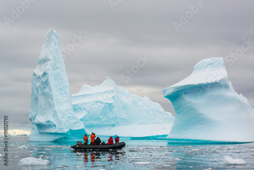 Zodiac cruising through icebergs, Antarctica photo