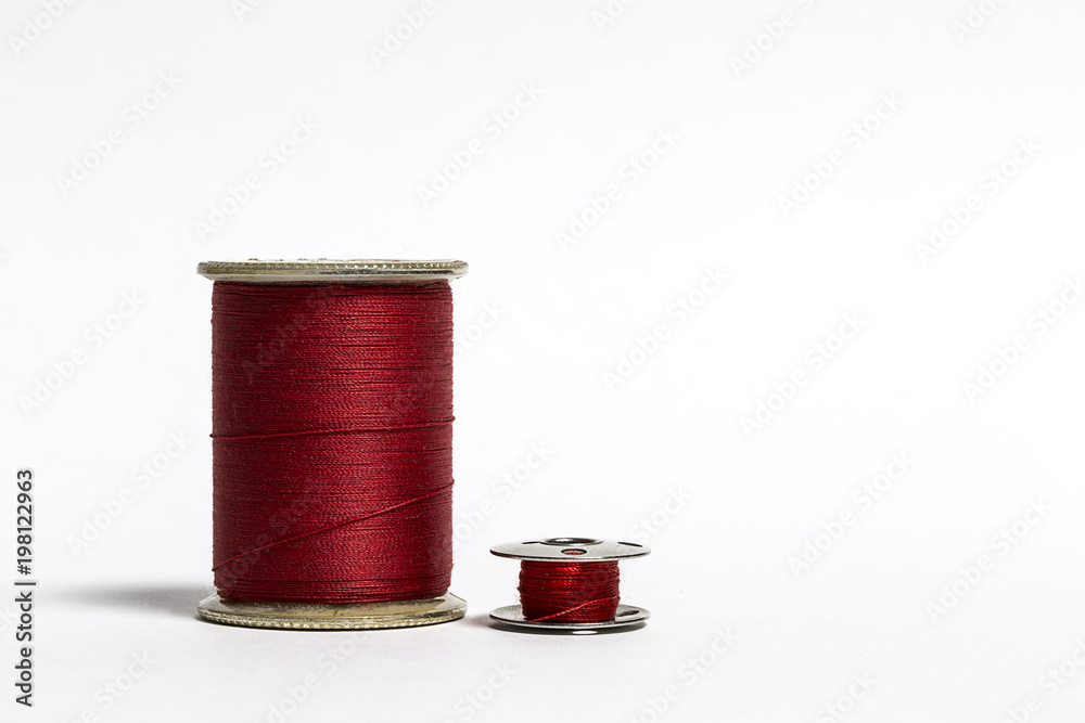 Spool of Red Thread with corresponding Bobbin Spool of Red Thread with corresponding Bobbin