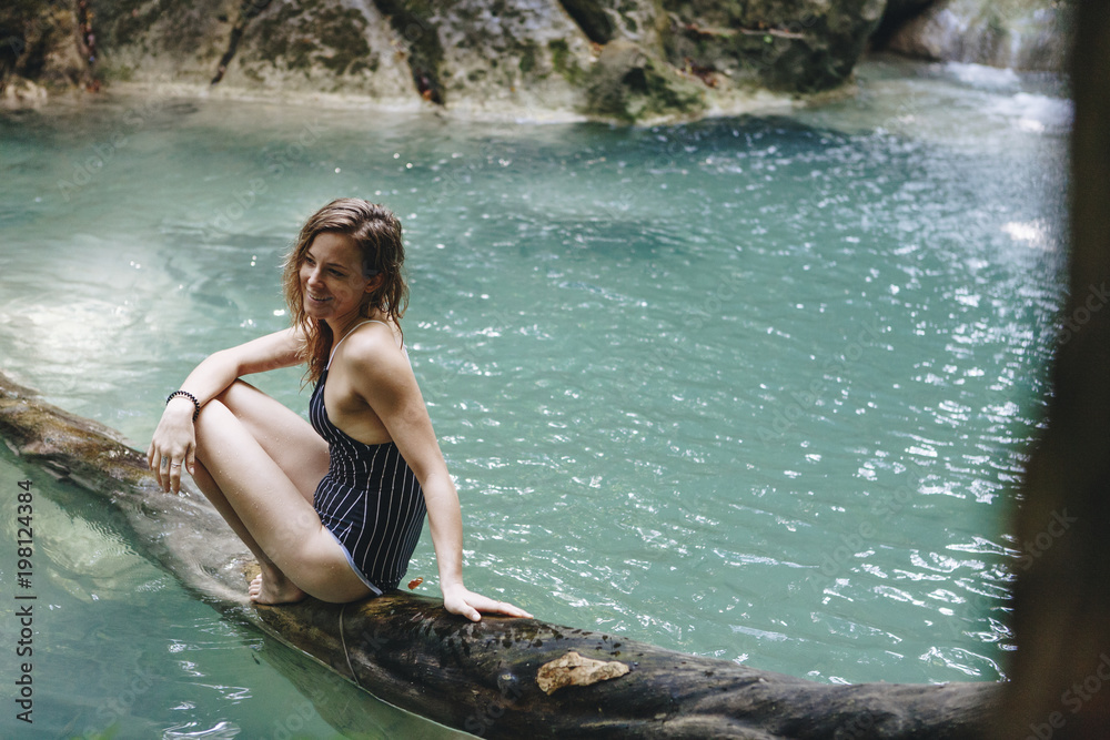 Fototapeta premium White woman enjoying the waterfall