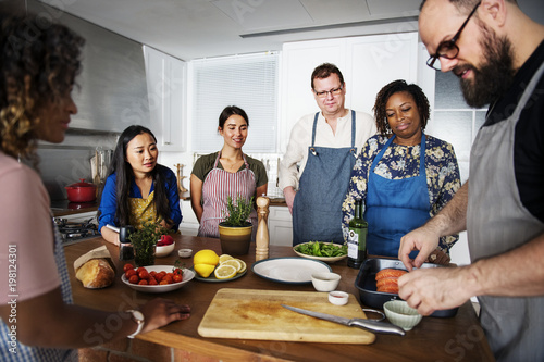 Diverse people joining cooking class photo