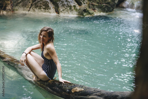 White woman enjoying the waterfall