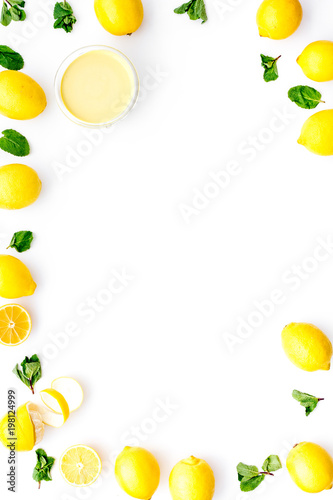 Lemon curd in bowl among lemons on white background top view copy space