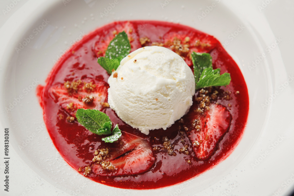 scoop of white ice cream with fruit in plate. Top view. scoop of white ice cream with fruit in plate. Top view.