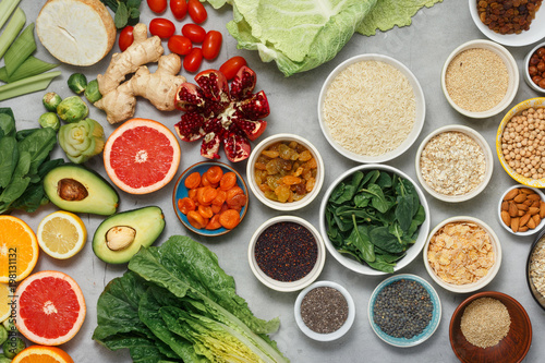 Clean eating concept.Vegetarian healthy food - different vegetables and fruits, superfood, seeds, cereal, leaf vegetable on light background, top view. Flat lay