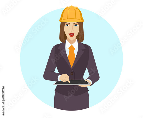 Businesswoman in construction helmet uses digital tablet PC