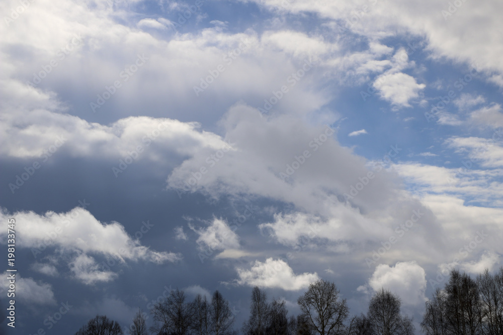Spring. blue sky with fluffy white clouds. sun, sunlight, clouds, sky - spring changeable weather. Spring. blue sky with fluffy white clouds. sun, sunlight, clouds, sky - spring changeable weather.