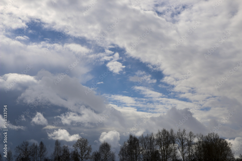 Spring. blue sky with fluffy white clouds. sun, sunlight, clouds, sky - spring changeable weather. Spring. blue sky with fluffy white clouds. sun, sunlight, clouds, sky - spring changeable weather.