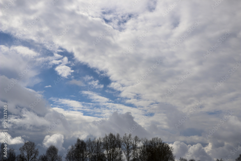 Spring. blue sky with fluffy white clouds. sun, sunlight, clouds, sky - spring changeable weather. Spring. blue sky with fluffy white clouds. sun, sunlight, clouds, sky - spring changeable weather.