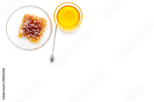 Apiary products. Honey in bowl and honeycomb on white background top view copy space