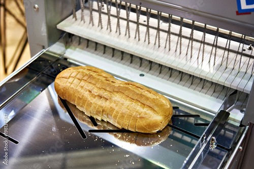 Sliced bread in cutting machine photo