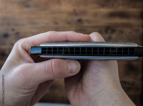 harmonica in the hands of a man