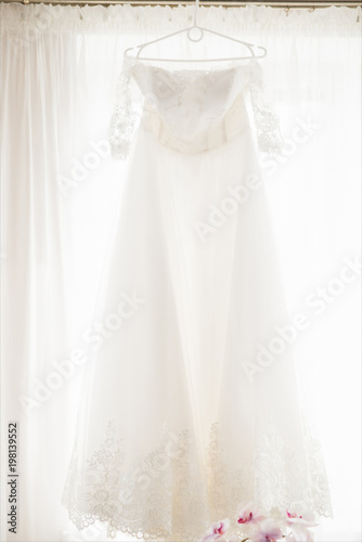 Wedding Dress Hanging in a Window