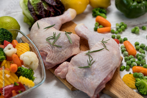 raw chicken legs from vegetables to a wooden table, preparing chicken legs for vegetables, Recipe - ingredients
