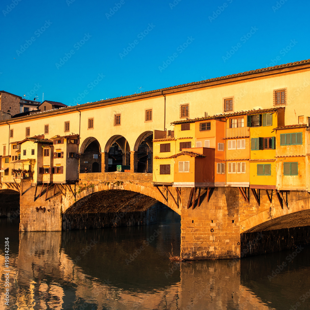 Florence, Italy - Ponte Vecchio over Arno River at sunset. Florence is a popular tourist destination of Europe. .