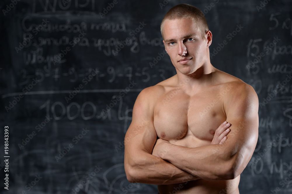 Model man bodybuilder posing on grey background
