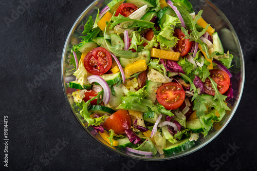 tomatoes, bell pepper, cucumber, lettuce and red onion salad