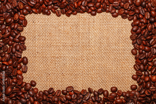 Frame on the background of a baggy cloth laid out of coffee beans in the form of a rectangle