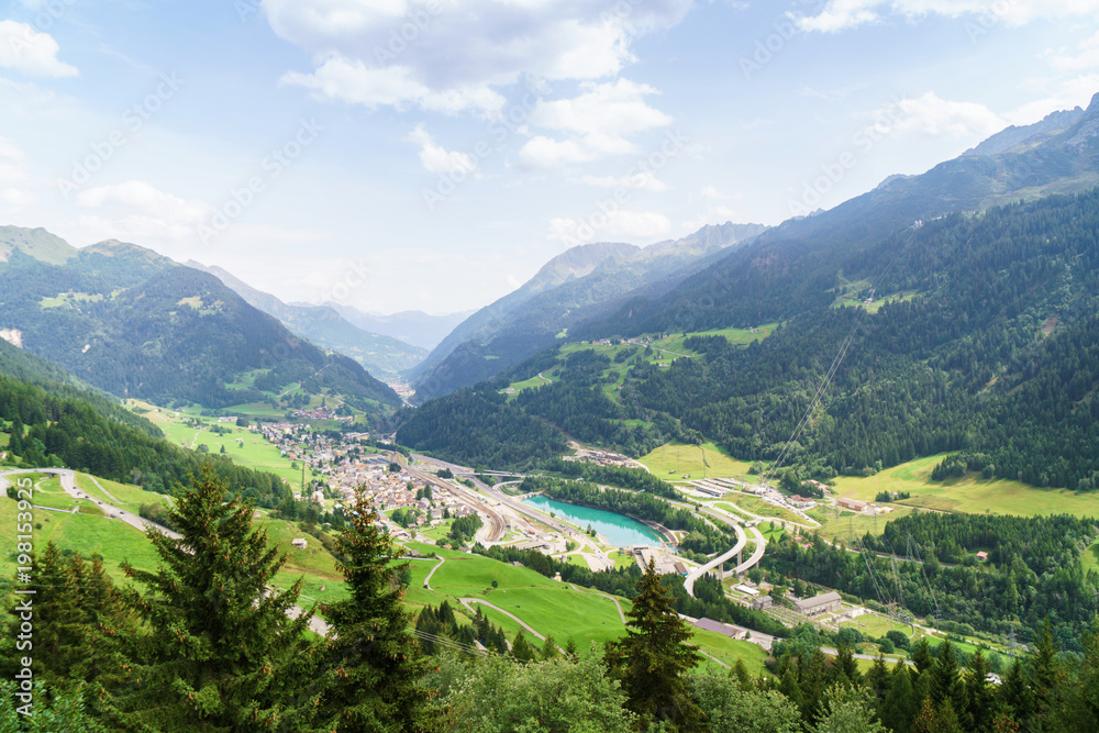Swiss landscape with Alpine village and a lake. 