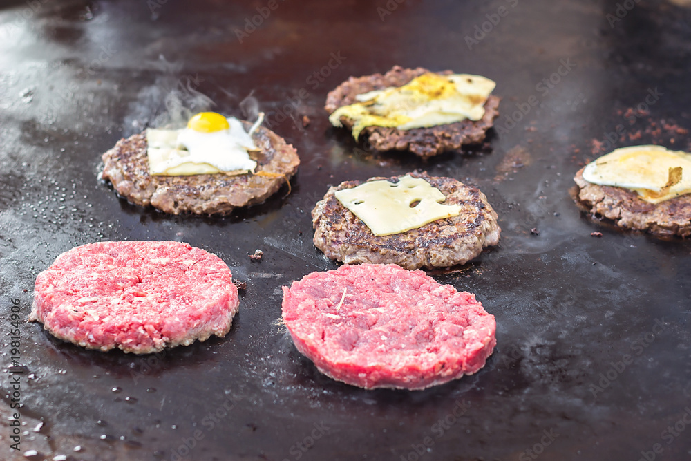 Cooking beef and pork patty for burger. Meat roasted on fire barbecue kebabs on the grill. Grilled burger cutlet beef minced meat patties or frikadeller in a pan. Street food, close up. Cooking beef and pork patty for burger. Meat roasted on fire barbecue kebabs on the grill. Grilled burger cutlet beef minced meat patties or frikadeller in a pan. Street food, close up.