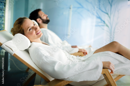 Handsome man and beautiful woman relaxing in spa