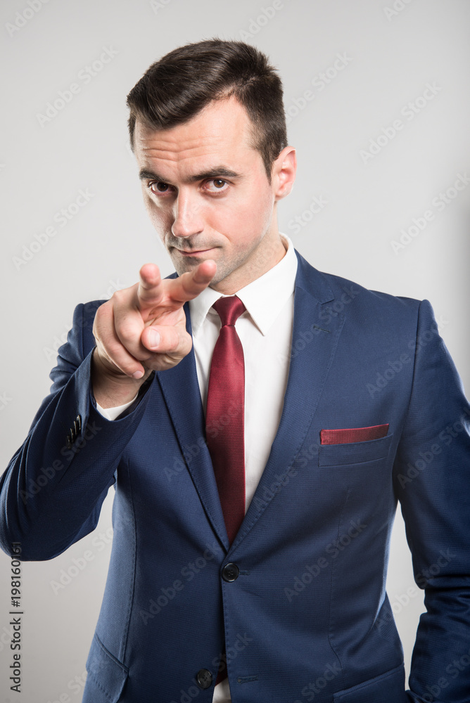 Attractive business man making watching you gesture Attractive business man making watching you gesture