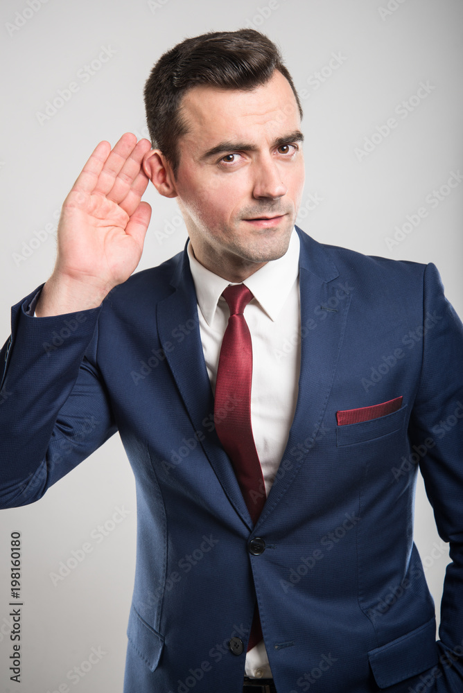 Attractive business man making can't hear gesture Attractive business man making can't hear gesture