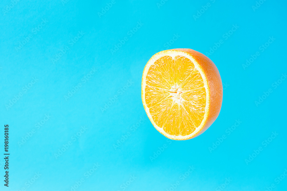 Ripe Juicy Halved Orange Floating Levitating in the Air on Light Blue Background. Vitamins Healthy Diet Summer Detox Vegan Superfoods Concept. Poster Banner Streamer Template. Copy Space Ripe Juicy Halved Orange Floating Levitating in the Air on Light Blue Background. Vitamins Healthy Diet Summer Detox Vegan Superfoods Concept. Poster Banner Streamer Template. Copy Space