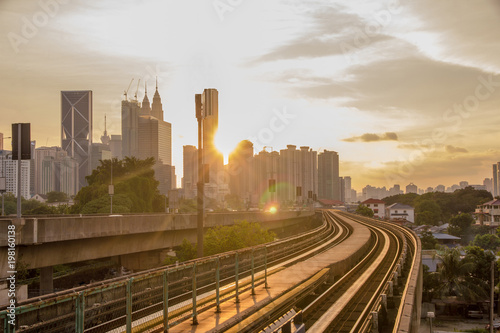 Sun rise brings a new day to the rapidly growing high tech city of Kuala Lumpur in Asia and is a good example of the regions booming economies and infrastructure photo