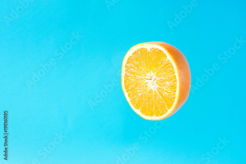 Ripe Juicy Halved Orange Floating Levitating in the Air on Light Blue Background. Vitamins Healthy Diet Summer Detox Vegan Superfoods Concept. Poster Banner Streamer Template. Copy Space
