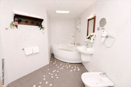Modern style interior design of a bathroom, hotels, bathroom with flowers