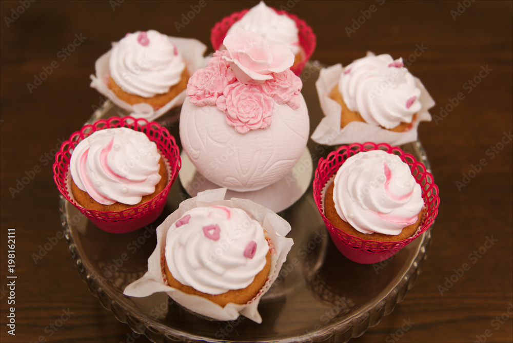 Red velvet cupcakes for Valentines Day in bright colorful setting, selection focus